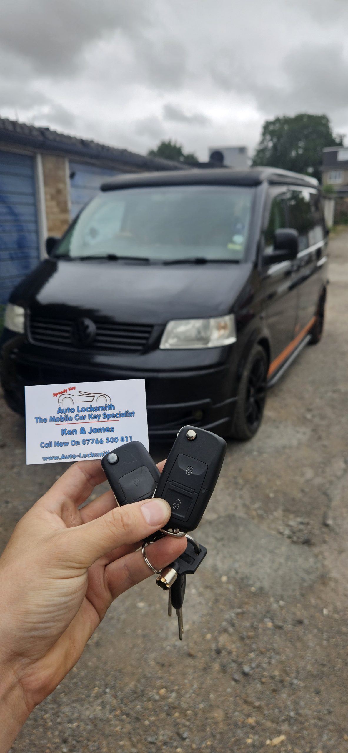 van replacement key held up to black van in essex