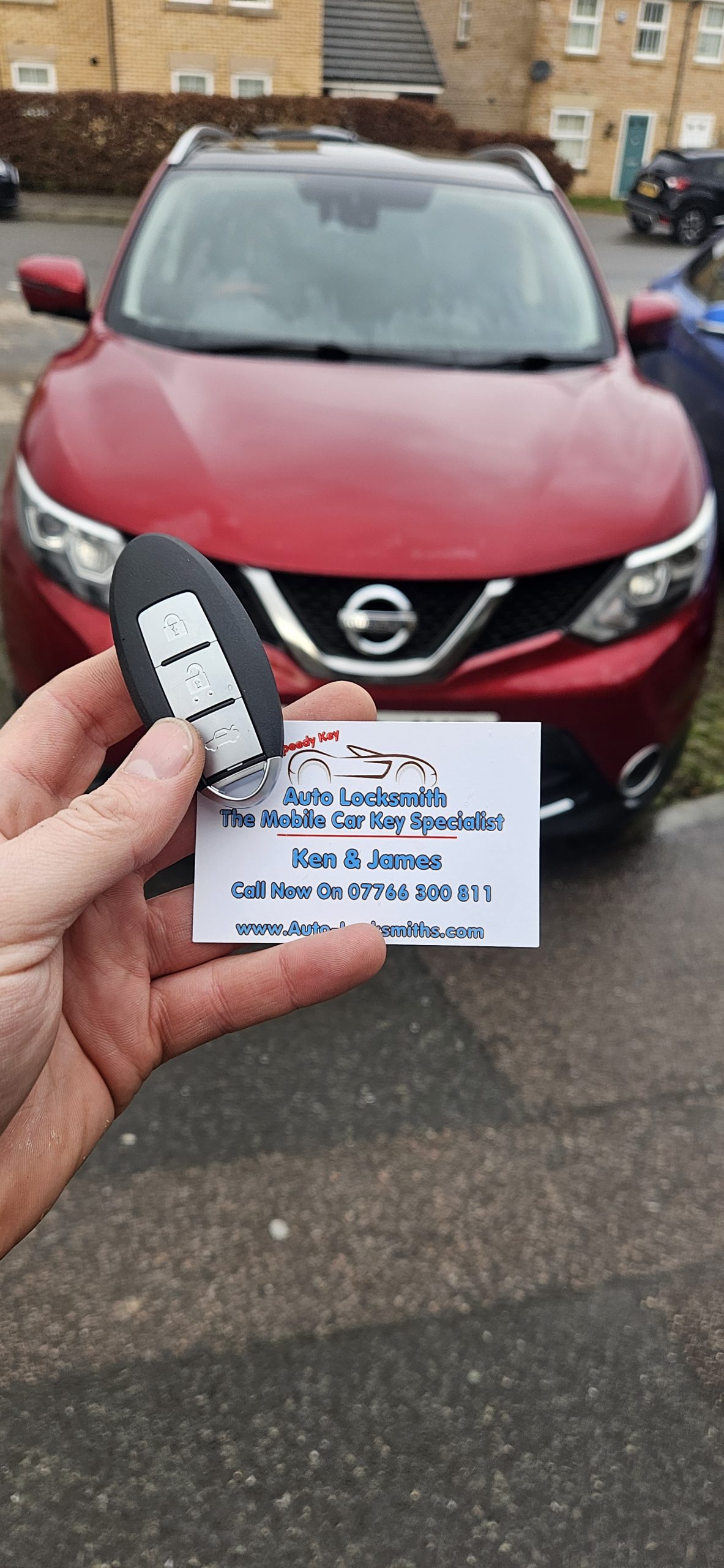 replacement car key held up to car in london